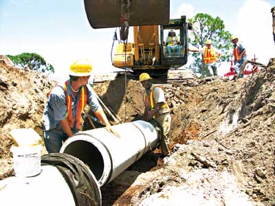 Rangers pipe crew on the project includes, from the left, Demango Reyes, C.W. Smith, Mike White (operating the excavator), James Phillips and Ricky Angel. Not shown is Pipe Foreman Johnny Brewer.