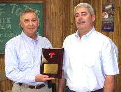 Mike Slade, left, President of Rangers Central Division, receives a plaque from Tim McGrath of Travelers recognizing the divisions no lost time achievements.