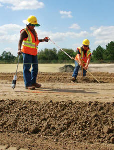 Margarita Quirino and Christine Crowell mark the road base for grading on Rangers design-build I-4 interchange improvement at SR-46 in Seminole County. (Photo by Carl Thiemann)
