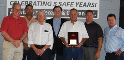 Sharpe Bros. VP Ivan Clayton holds a plaque from Steve Beals with Travelers, far right, marking five years with no lost time incidents. Also shown are Vecellio Group VP Safety John West, Sharpe Division Safety Manager John Riley Jr., Vecellio & Grogan President Bill Medcalf, Vecellio Group VP Michael Vecellio and VP Safety Mark Ligon. (Photo by Gloria Fields)