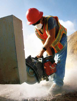 In East Beckley, WV, Jarrel Truman cuts a section of precast concrete for building a retaining wall. (Photo by Carl Thiemann) 