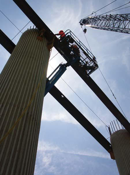 Vecellio & Grogan was recently featured in a national magazine's photo contest showcasing construction projects around the country. A photo taken by Vecellio Group Communications Director Carl Thiemann shows V&G crew members Argel Cook, Jr. and Greg Timberlake silhouetted against the sky as they secure steel girders near the top of a row of bridge piers.